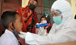Paramedics of Puskesmas Kebayoran Lama check the temperature and vaccinate the students of...