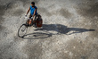 A delivery man carrying gas cylinders during lockdown imposed by the government amid conce...