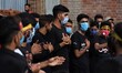 Shiite Muslim mourners wearing face masks take part in the Muharram Processions during the...