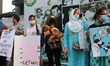 Supporters of animal rights groups form a human chain in protest against the decision of D...