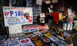 A man sells COVID-19 themed shirts bundled with free face shield in Manila, Philippines on...