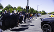 Parasol Patrol, a local protest group, block the roads with umbrellas allowing protesters...