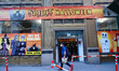 A person wearing a mask passes by a Halloween store as New York City continues Phase 4 of...