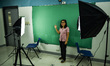 A teacher makes use of green screen in filming lectures in preparation for the opening of...