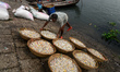 Worker washes recycled plastic chips in the river Buriganga in Dhaka, Bangladesh on Octobe...