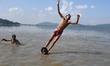 Boys  jump in the Brahmaputra river during an a hot summer day in Guwahati ,india on Oct 1...