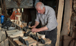A carpenter makes a wooden sandals in his workshop in the old town of Nablus city West Ban...