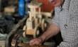 A carpenter makes a wooden sandals in his workshop in the old town of Nablus city West Ban...