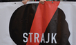 An activist holds 'Women's Strike' banner on Krakow's Grodzka Street during the Pro-Choice...