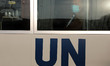 A UN employee, mask-clad due to the COVID-19 coronavirus pandemic, rides a company bus on...