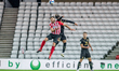  David Kasumu wins a header clearing the ball during the Sky Bet League 1 match between Su...