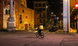 A rider is seen in San Babila square in Milan at night during the lockdown period due to t...