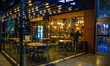 People wearing protective face masks are seen inside a restaurant amid the coronavirus (CO...