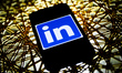 LinkedIn logo is seen displayed on a phone screen in this illustration photo taken in Pola...