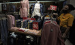 A shop assistant wearing protective masks wait costumers at a store in Botani Square mall,...