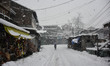 A man walks amid heavy snowfall as snowfall contimues for third day in Srinagar, Indian Ad...