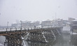 A man walks amid heavy snowfall on a bridge as snowfall contimues for third day in Srinaga...