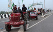 Farmers participate in a tractor rally to protest against the newly passed farm bills, at...