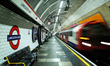 A Central line tube train pulls into a near-empty platform at Lancaster Gate Station on th...