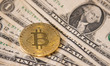 Bitcoin golden physical coin illustration on United States Dollar banknotes. Visual repres...