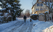 Man walking wih a dog by the road covered with a thick layer of snow is seen in Gdansk, Po...
