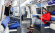 Londoners in protective face masks are seen commuting in London Tube as the UK's governmen...