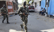 Paramilitary forces march along a road ahead of the West Bengal Assembly elections in Kolk...