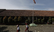 Indonesian students wear protective mask walk at Tegalwaru 02 elementary school in Bogor R...