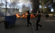Students carry a dead tree during the first day of student strikes to protest a government...