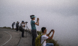 People take photo of a view from Tai Mo Shan in Hong Kong, Friday, March 19, 2021. 