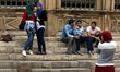 Two Egyptian girls pose while a friend makes a photograph on Al Moe'z Street near Al Husse...
