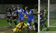Grimsby Town's  James McKeown bundles the ball out for a corner under pressure from Barrow...