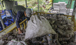 Workers collect plastic glass waste to be cut at the Citra Waste Processing House (RPSC),...