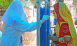 A health worker takes sample from a woman for COVID-19 test, as coronavirus cases surge ac...