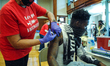 A patient looks away as he gets a shot of the single-dose Johnson and Johnson vaccine at a...