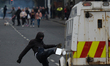 A loyalist protester seen in front of a PSNI vehicle during further unrest on Lanark Way i...