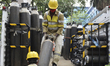 Workers load oxygen cylinders in a truck amid coronavirus emergency in Kolkata, India, 22...