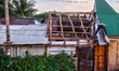 Rapa Nui men repair the roof of a building in the small town of Hanga Roa in Easter Island...