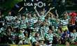 Sporting's players celebrate with their trophy the Portuguese League football title after...