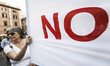 A protester holds a banner reading 'No' as she takes part in a rally to support ‘No’ vote...