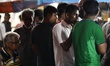 People gather in a tea stall during rainfall in Dhaka, Bangladesh on May 18, 2021 