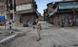 Indian forces stand alert during the strictest Covid-19 curfew on the anniversary of the a...