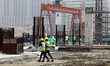 Workers during a break from work at a construction site of  Hazrat Shahjalal International...