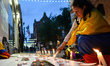 A member of the Colombian Diaspora in Dublin lights a candle during the Candlelight Vigil...