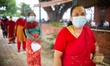 Nepalese people line up to receive a dose of the Vero cell COVID-19 vaccine in Bhaktapur,...