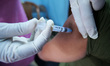 A health worker inoculates a dosage of the Covishield vaccine against the Covid-19 coronav...
