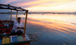 A man works on his boat in Dal Lake during sunset in Srinagar, Indian Administered Kashmir...