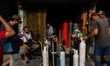 Indonesians queue at an oxygen refill shop amid the rising number of self-isolation, in Ja...