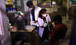 A Health worker Inoculates People with a dose of the Covid-19 coronavirus vaccine at a vac...