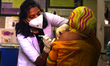 A Health worker Inoculates People with a dose of the Covid-19 coronavirus vaccine at a vac...